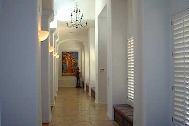 Hallway - large traditional concrete floor hallway idea in Phoenix with white walls