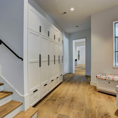 Inspiration for a transitional medium tone wood floor and brown floor hallway remodel in Houston with white walls