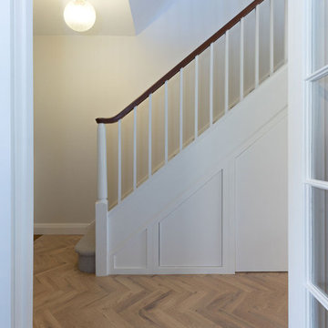 Under-stair storage and newly installed wooden parquet floor
