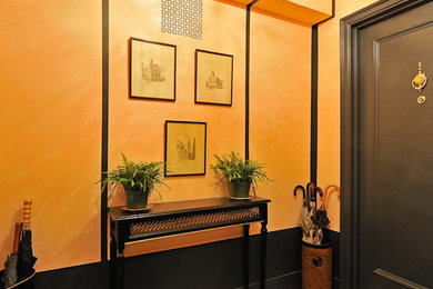 Inspiration for a small timeless carpeted hallway remodel in New York with orange walls