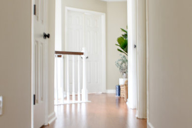 Example of a mid-sized transitional medium tone wood floor hallway design in Nashville with beige walls