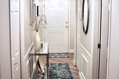 Example of a mid-sized transitional laminate floor and brown floor hallway design in Vancouver with gray walls