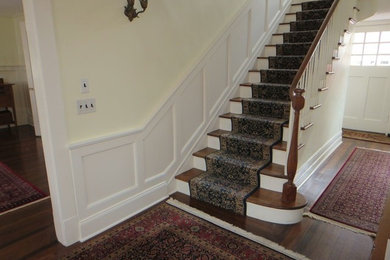 Example of a mid-sized classic dark wood floor and brown floor hallway design in New York with beige walls