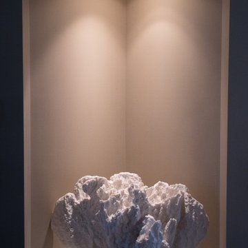 White Coral Sculpture highlighted by recessed lighting inside a niche wall
