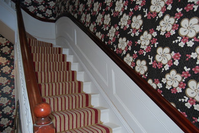 White painted panelling and stained mahogany bannister