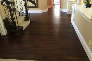 Hallway - mid-sized traditional dark wood floor and brown floor hallway idea in Orange County with beige walls
