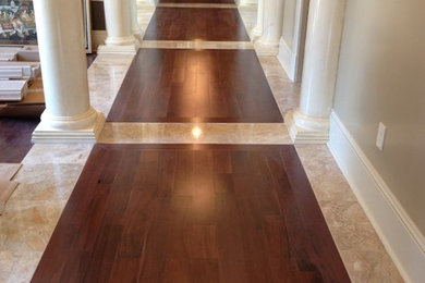 Example of a medium tone wood floor hallway design in New Orleans