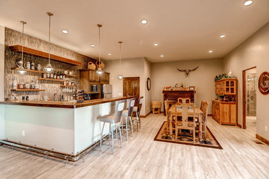 Large southwest ceramic tile home bar photo in Denver
