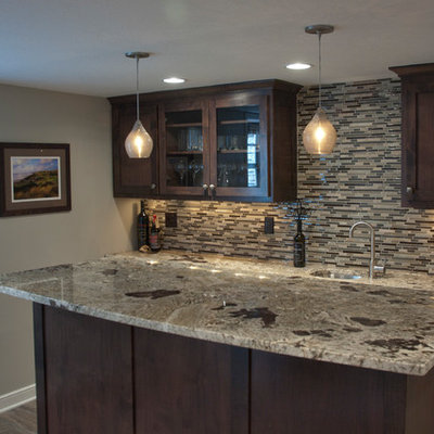 Large trendy galley wet bar photo in Minneapolis with an undermount sink, flat-panel cabinets, dark wood cabinets, granite countertops, brown backsplash and glass tile backsplash