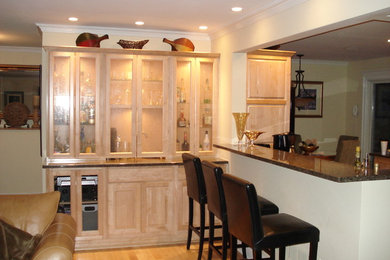 Mid-sized elegant light wood floor seated home bar photo in Chicago with raised-panel cabinets, light wood cabinets and granite countertops