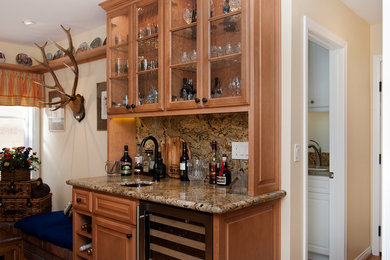 Inspiration for a mid-sized transitional single-wall wet bar remodel in Phoenix with an undermount sink, glass-front cabinets, light wood cabinets, multicolored backsplash and stone slab backsplash