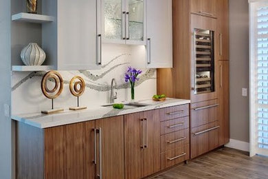 Example of a mid-sized transitional single-wall brown floor and porcelain tile wet bar design in Sacramento with an undermount sink, flat-panel cabinets, medium tone wood cabinets, white backsplash, white countertops and quartz countertops