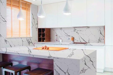 Inspiration for a large modern l-shaped ceramic tile and white floor kitchen remodel in Miami with a drop-in sink, flat-panel cabinets and white cabinets