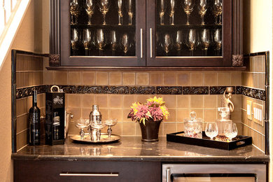 Inspiration for a contemporary home bar in Tampa with raised-panel cabinets and dark wood cabinets.