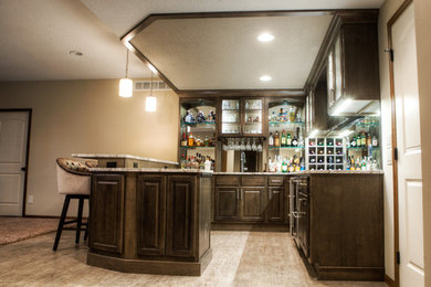 Large transitional u-shaped vinyl floor and gray floor wet bar photo in Other with an undermount sink, raised-panel cabinets, dark wood cabinets, quartz countertops, multicolored backsplash and mirror backsplash