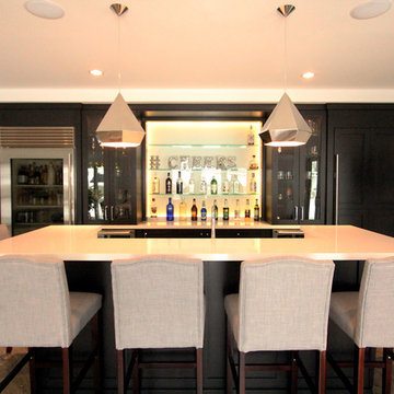 Basement Bar with Island Featuring Bar Height Seating and Undermount Sink