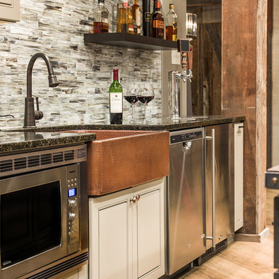 Example of a large mountain style porcelain tile wet bar design in Chicago with a drop-in sink, raised-panel cabinets, gray cabinets, granite countertops, multicolored backsplash and glass tile backsplash