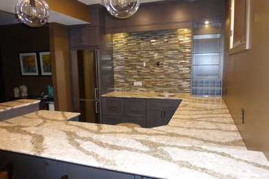 Wet bar - mid-sized transitional u-shaped wet bar idea in Other with an undermount sink, flat-panel cabinets, gray cabinets, quartz countertops and multicolored backsplash
