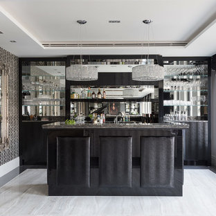 Medium sized contemporary galley wet bar in Hertfordshire with a submerged sink, flat-panel cabinets, black cabinets, granite worktops, mirror splashback, black worktops and grey floors.