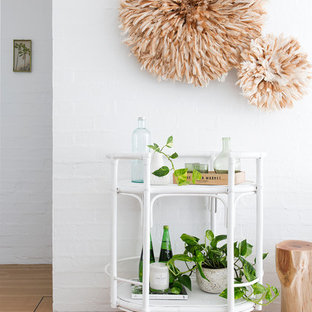 Beach style bar cart in Brisbane with medium hardwood floors and brown floor.