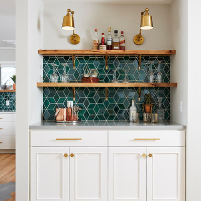 Example of a transitional single-wall light wood floor and beige floor home bar design in Minneapolis with white cabinets, ceramic backsplash, no sink, recessed-panel cabinets, green backsplash and gray countertops