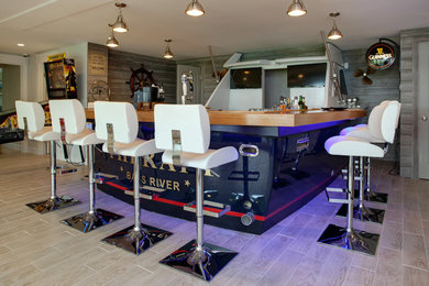 Example of a large beach style u-shaped vinyl floor and brown floor seated home bar design in Boston with an undermount sink, wood countertops and brown countertops