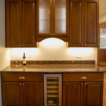 Butler's pantry with wine refrigerator and cabinets.