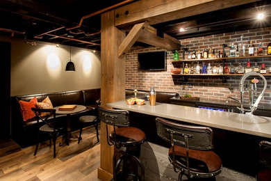 Seated home bar - mid-sized rustic galley medium tone wood floor and brown floor seated home bar idea in Seattle with solid surface countertops, red backsplash, brick backsplash and open cabinets
