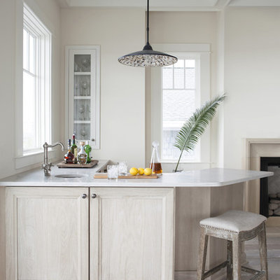 Inspiration for a mid-sized coastal l-shaped light wood floor and beige floor wet bar remodel in Atlanta with an undermount sink, recessed-panel cabinets, light wood cabinets, quartz countertops and white countertops