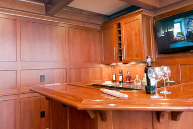 Small elegant u-shaped medium tone wood floor seated home bar photo in Other with an undermount sink, shaker cabinets, medium tone wood cabinets and granite countertops