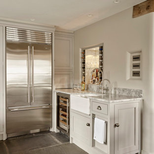 Photo of a large rural home bar in Other with beaded cabinets, blue cabinets, grey floors and grey worktops.