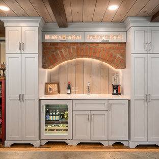 Huge elegant single-wall medium tone wood floor wet bar photo in Columbus with shaker cabinets, quartz countertops, white countertops, an undermount sink, gray cabinets and wood backsplash
