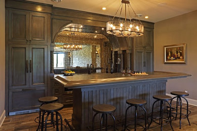 Ispirazione per un bancone bar tradizionale di medie dimensioni con ante a filo, ante in legno bruno, paraspruzzi a specchio, parquet scuro, pavimento marrone e top marrone