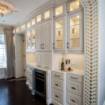 Custom Couture Master Closet with White Raised Panel Cabinetry, Gold Leaf Accent