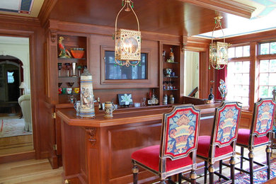 Seated home bar - traditional galley light wood floor and brown floor seated home bar idea in Philadelphia with medium tone wood cabinets, wood countertops and brown countertops