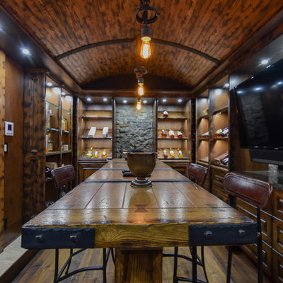 Large mountain style u-shaped medium tone wood floor and brown floor seated home bar photo in Edmonton with raised-panel cabinets, dark wood cabinets, wood countertops, brown backsplash and wood backsplash