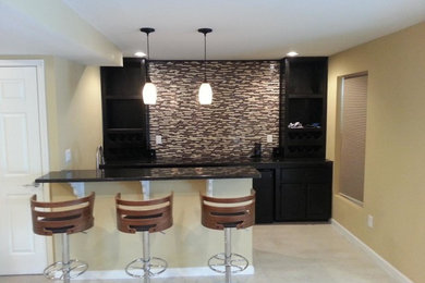 Example of a mid-sized minimalist galley travertine floor and beige floor seated home bar design in Philadelphia with an undermount sink, flat-panel cabinets, black cabinets, granite countertops, multicolored backsplash and matchstick tile backsplash