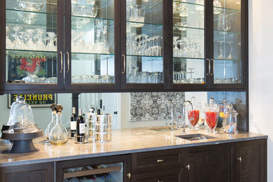 This is an example of a medium sized classic galley wet bar in St Louis with a submerged sink, shaker cabinets, dark wood cabinets, granite worktops, mirror splashback and medium hardwood flooring.