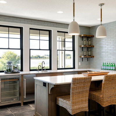 Inspiration for a large coastal u-shaped ceramic tile and brown floor seated home bar remodel in Minneapolis with quartz countertops, gray backsplash, white countertops, an undermount sink and subway tile backsplash