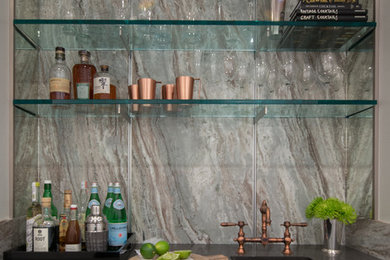 Wet bar - transitional single-wall medium tone wood floor and brown floor wet bar idea in New York with a drop-in sink, shaker cabinets, white cabinets, quartz countertops, gray backsplash and marble backsplash