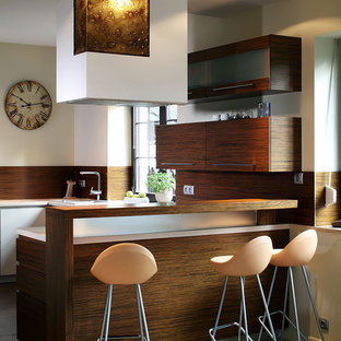 Trendy u-shaped seated home bar photo in Other with flat-panel cabinets, dark wood cabinets and brown backsplash