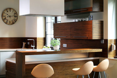 Trendy u-shaped seated home bar photo in Other with flat-panel cabinets, dark wood cabinets and brown backsplash