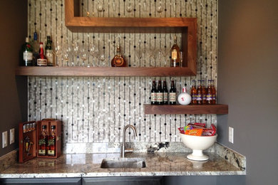Transitional wet bar photo in Nashville with an undermount sink, black cabinets and granite countertops