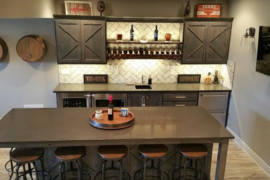 Inspiration for a large rustic single-wall brown floor and vinyl floor seated home bar remodel in Kansas City with an undermount sink, shaker cabinets, dark wood cabinets, solid surface countertops, white backsplash, subway tile backsplash and brown countertops