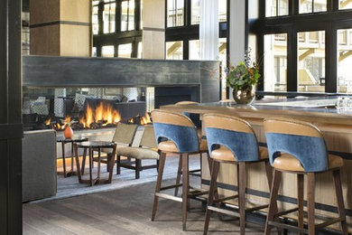 Inspiration for a large contemporary u-shaped painted wood floor seated home bar remodel in Denver with light wood cabinets and wood countertops