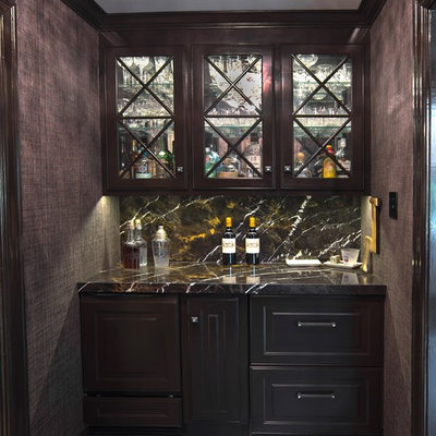 Example of a small trendy single-wall porcelain tile and gray floor wet bar design in St Louis with no sink, raised-panel cabinets, dark wood cabinets, granite countertops, brown backsplash and stone slab backsplash