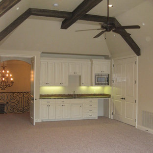 Example of a large classic single-wall carpeted wet bar design in Dallas with an undermount sink, raised-panel cabinets, white cabinets and granite countertops
