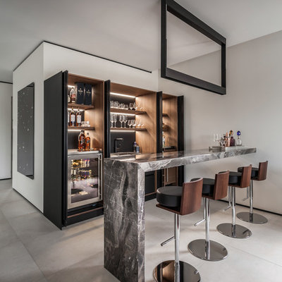 Inspiration for a large contemporary galley porcelain tile and gray floor wet bar remodel in Miami with dark wood cabinets, marble countertops, a drop-in sink, black backsplash, gray countertops and open cabinets