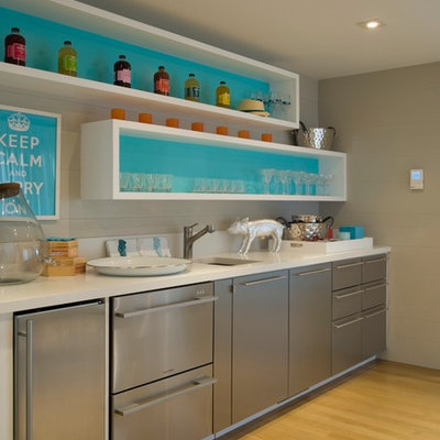 Beach style single-wall medium tone wood floor wet bar photo in New York with an undermount sink, flat-panel cabinets and white countertops