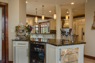 Example of a huge tuscan u-shaped marble floor and white floor home bar design in Milwaukee with raised-panel cabinets, white cabinets and granite countertops